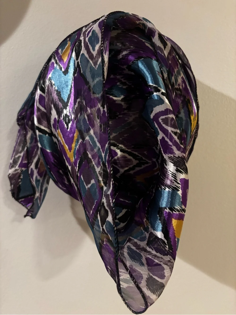 satin scarf featuring a vibrant purple and teal abstract ikat chevron